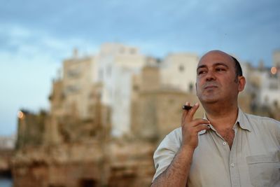 Low angle view of man smoking against sky