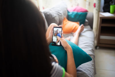 Midsection of woman using mobile phone