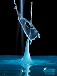 Close-up of water drop over black background