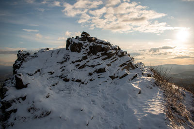 Scenic view of snowcapped mountains against sky during sunset