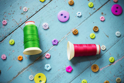 High angle view of multi colored buttons on table
