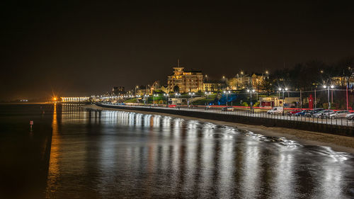 Illuminated city at waterfront