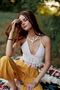 Young woman sitting on field