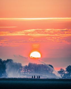 Scenic view of sunset over land