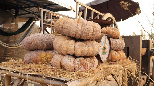 Stack of firewood for sale at market stall