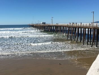 Pier over sea against clear sky