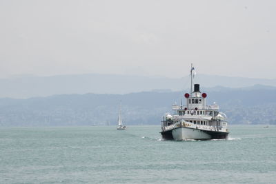 Boat sailing on sea against sky