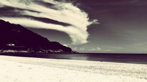 Scenic view of sea against cloudy sky