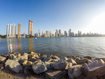 Panoramic view of sea and buildings against clear sky