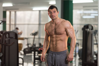 Portrait of shirtless man standing in gym