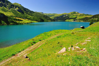 Scenic view of lake and mountains against sky