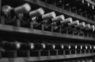 Full frame shot of wine bottles in shelf