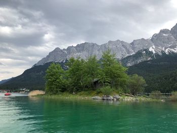 Scenic view of lake and mountains against sky