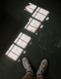 Low section of man standing on floor