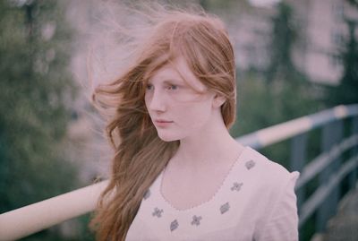 Close-up of young woman against blurred background