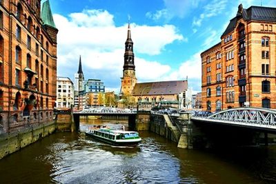 Boats in river with buildings in background