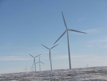 Wind turbines against sky