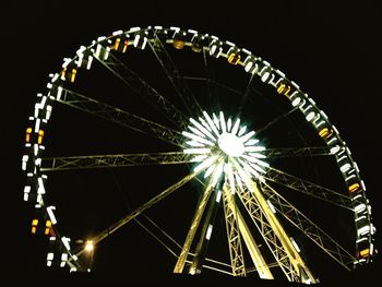 Low angle view of ferris wheel against sky at night