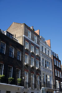 Low angle view of buildings against clear sky