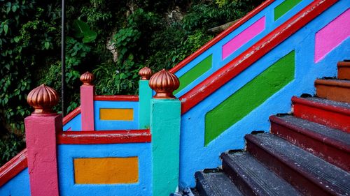 Full frame shot of multi colored wooden railing by plants