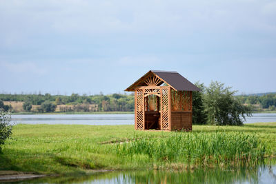 Built structure by lake against sky