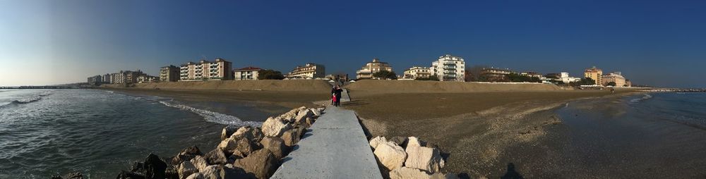 Panoramic view of sea against clear blue sky