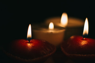 Close-up of lit tea light candles at night