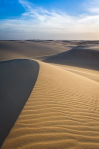 Scenic view of desert against sky during sunset