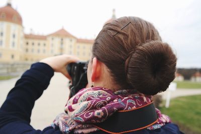 Rear view of woman photographing