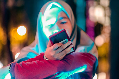 Teenage girl holding mobile phone