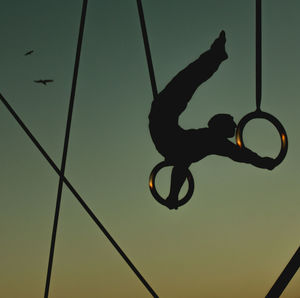 Low angle view of athlete against clear sky