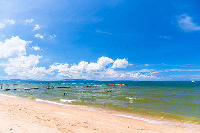 Scenic view of beach against blue sky