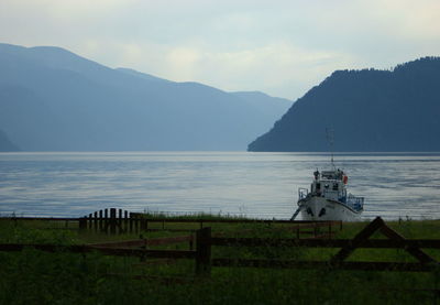 Scenic view of sea and mountains against sky