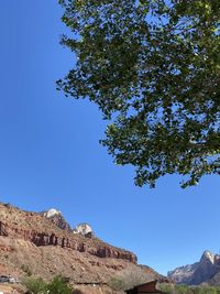 Low angle view of mountain against clear blue sky