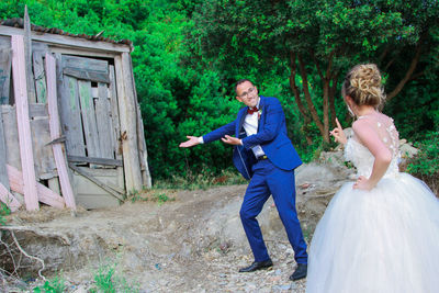 Full length of couple standing on field