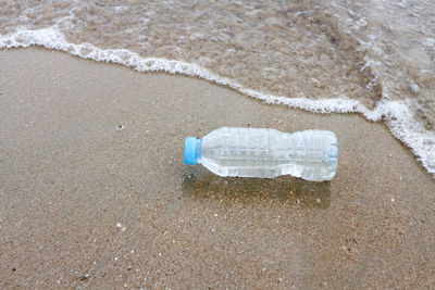 Bottle on shore at beach