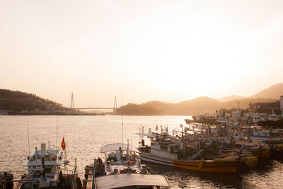 Boats sailing in sea against clear sky