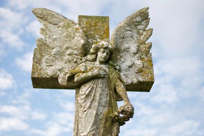 Low angle view of statue against sky