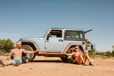 Male and female hikers cheers from afar after reaching their camp