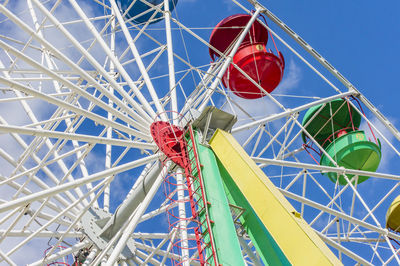 Low angle view of ferris wheel against blue sky