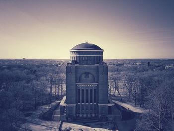 Abandoned built structure on landscape against clear sky