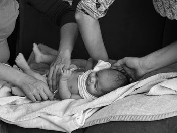 Cropped image of parents wearing clothes to baby son