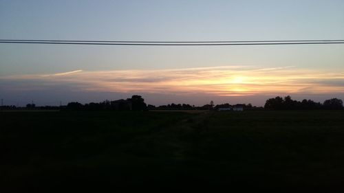 Scenic view of field against sky during sunset