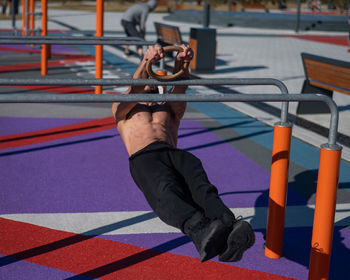 Full length of muscular man exercising outdoors