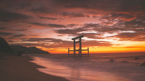 Scenic view of beach against sky during sunset