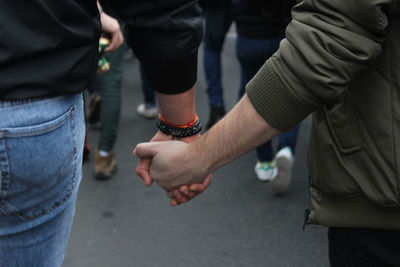 Midsection of man holding hands