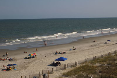 People on beach against sky