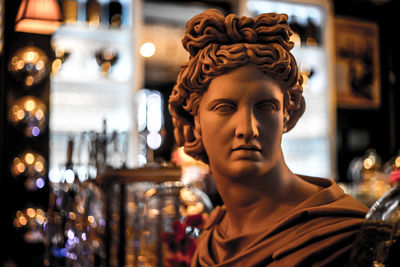 Close-up of male statue in illuminated bar