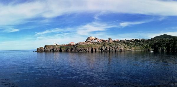 Panoramic view of sea and buildings against sky