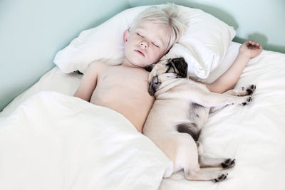 Boy sleeping with pug